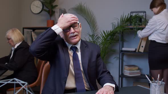 Bored Senior Man Boss Doing Face Palm Gesture While Developing New Project on Laptop Computer