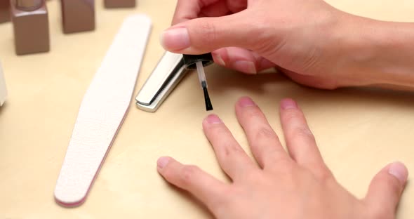 Woman making manicure at home