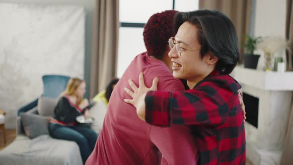 Close Up of Two Cheerful Friends Meet on the Party Greeting Each Other and Huging