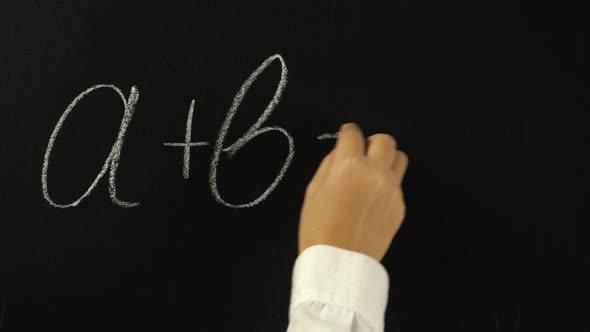 Hand Writing with Chalk on Chalkboard Mathematical Equation, a Plus b Equals c
