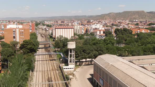 Railway road leading through suburbs of Madrid, aerial drone view