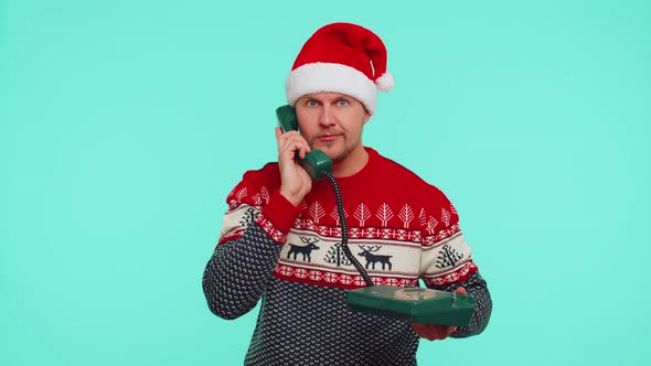 Funny Man in Christmas Sweater Talking on Wired Vintage Telephone of 80s Says Hey you Call Me Back