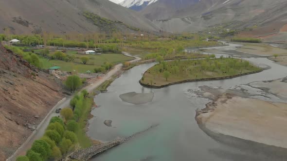 Aerial View Along Road Beside River In Ghizer Valley District In Pakistan. Dolly Forward