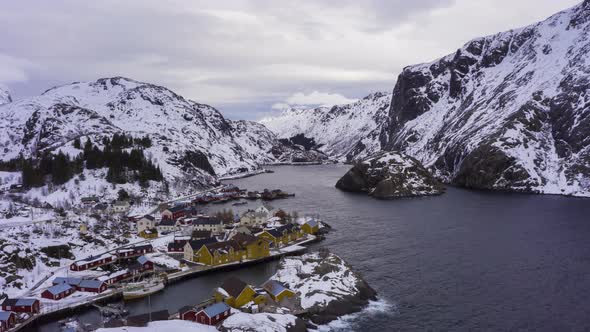 Nusfjord Village and Mountains in Winter. Lofoten Islands, Norway. Aerial View