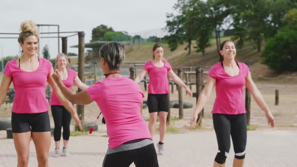 Female friends enjoying exercising at boot camp together