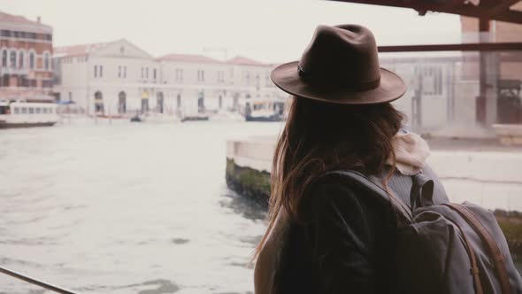 Back View of Young Tourist Woman Enjoying Beautiful Boat Excursion Tour Along Big City River 