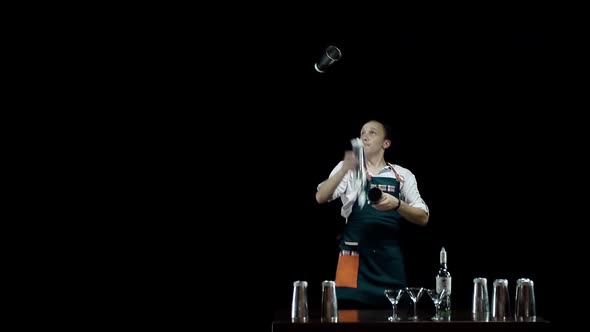 Professional Bartender in Apron Juggles Bottles