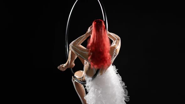 Gorgeous Slim Caucasian Woman Spinning on Air Hoop in Slow Motion Rubbing Hands Caressing Red Hair