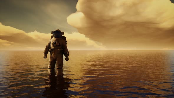 Spaceman in the Sea Under Clouds at Sunset