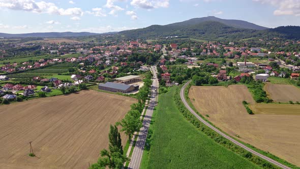 Aerial view of village near mountains. Countryside landscape