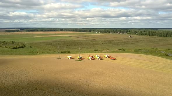 Bird Eye View Harvesters and Truck Stand on Yellow Field