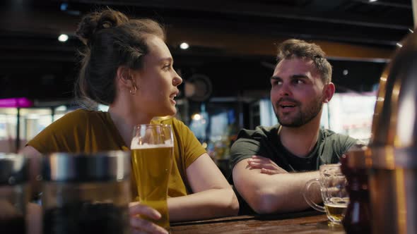 Caucasian man and woman talking together in the bar. Shot with RED helium camera in 8K. 