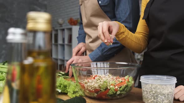 Cooking Salad at Home Woman Hands Adding Mung Bean Sprouts To a Salad