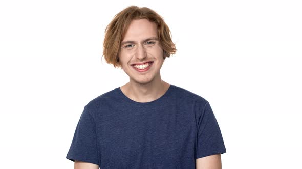 Portrait of Joyous Hairy Man in Casual Tshirt Laughing with Perfect Teeth and Expressing Joy