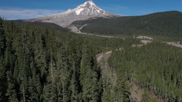 Aerial scenic reveal shot of Mt. Hood in the Cascade mountain range in Oregon.