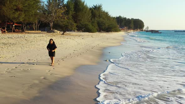 Woman loves life on marine lagoon beach trip by blue sea and white sand background of the Maldives n