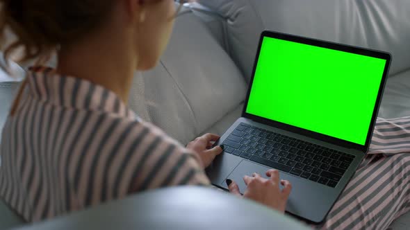 Woman Looking Green Screen Laptop at Remote Workplace Closeup