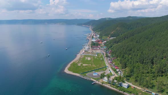 Aerial Video Footage of a Green Forest and Houses on the Lake