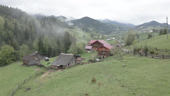 Ukraine, Carpathian Mountains: Village in the Mountains. Aerial, Flat, Gray