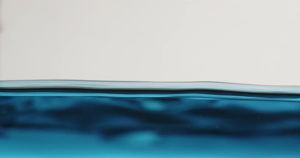 Blue Water Surface In Motion With Waves Creating Abstract Shapes