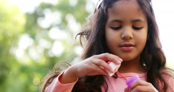 Girl blowing soap bubbles