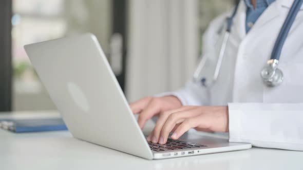 Close Up of Doctor Typing on Laptop