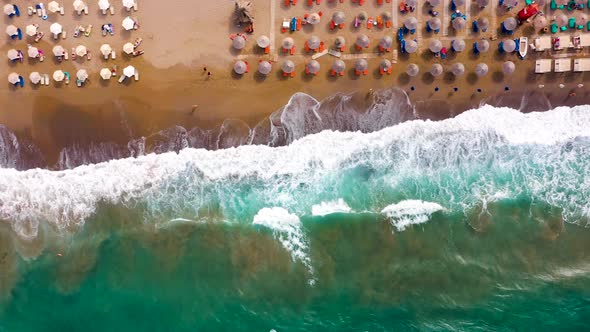 Aerial View of the Sea Sandy Beach Sun Umbrellas and Sunbeds Unrecognizable People