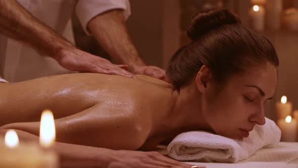 Attractive Woman Lying on Massage Table in Spa Resort in Slowmotion