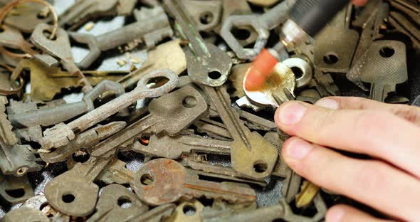 Locksmith in workshop makes new key, use grinding engraving machine