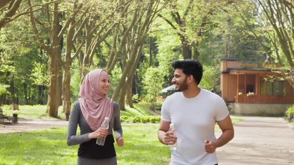 Arabian Couple Enjoying Morning Run at Park