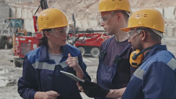 Quarry Workers with Tablet Talking