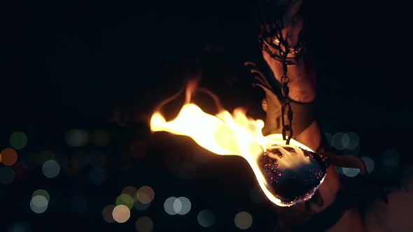 Close-up Shot of Burning Poi Hanging on Chain.