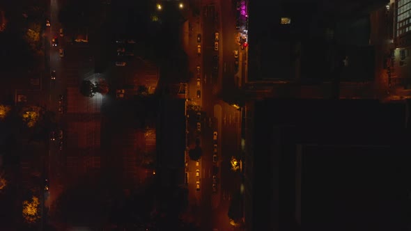 Aerial Birds Eye Overhead Top Down Shot of Illuminated Streets in Night City