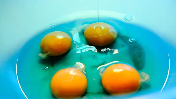 chicken eggs.raw eggs without shell.The egg flows and falls into the cup.