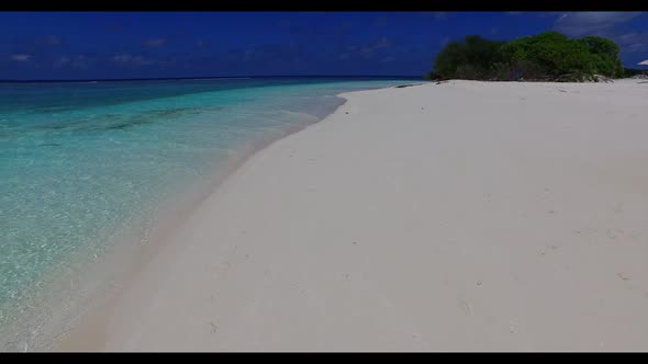 Aerial drone view panorama of tranquil lagoon beach lifestyle by shallow ocean with bright sand back