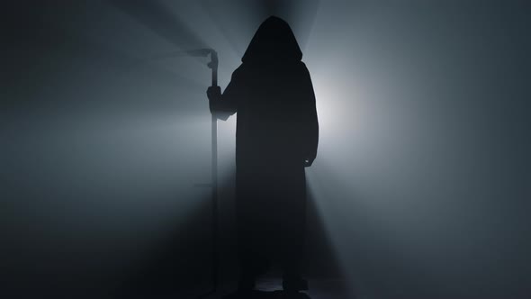 Silhouette Grim Reaper Standing Indoors