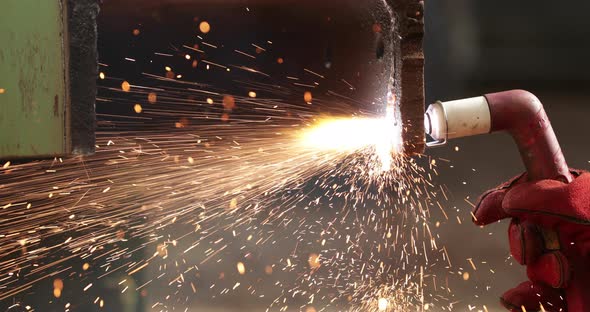 Sparks From A Blow Torch Cutting Rusty Steel In Slow Motion - close up