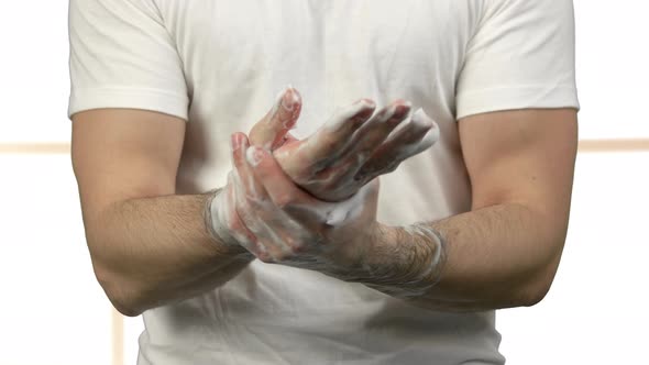 Close Up Portrait of Young Man Washing His Hands with Soap Foam