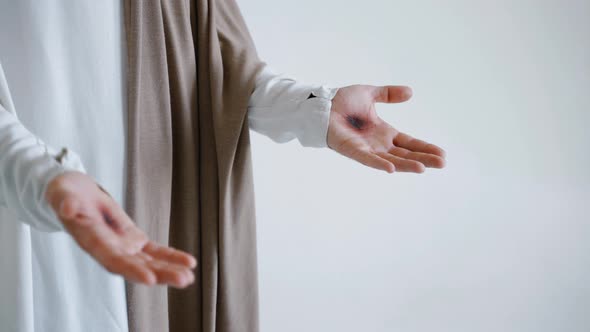 Jesus' Hands with Stigmata on a White Background