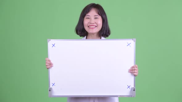 Happy Asian Businesswoman Holding White Board