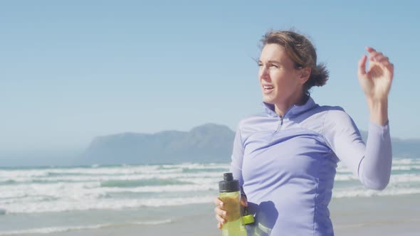 Tired athletic woman on the beach