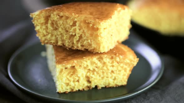 Time-lapse. Slice of sweet cornbread with honey on the plate