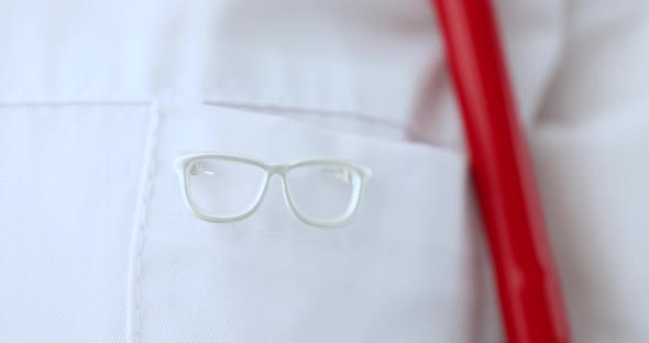 Ophthalmologist in White Coat on Pocket with Glasses Sign