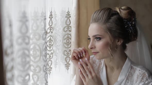 Beautiful and Lovely Bride in Night Gown and Veil. Wedding Morning