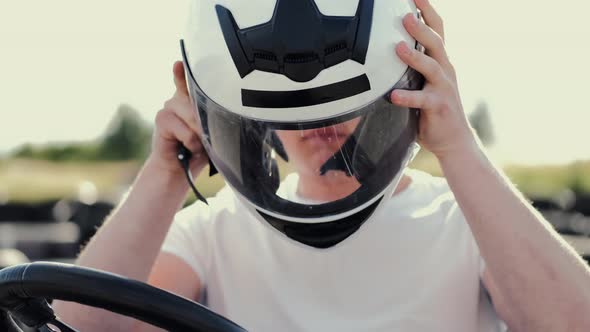 Attractive Man Sititng in a Gocart on the Track