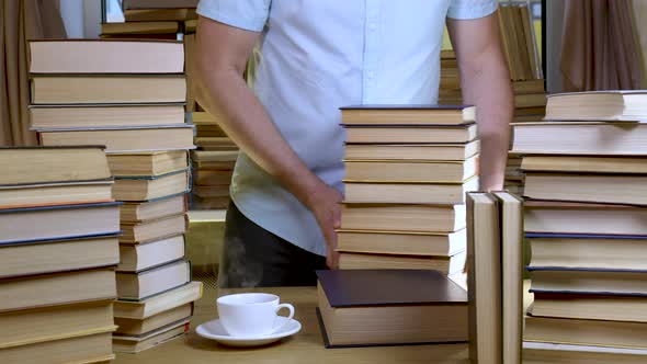 A Bearded Man Reads a Book in the Library