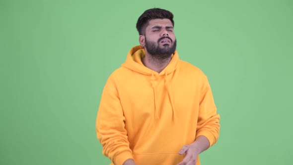 Stressed Young Overweight Bearded Indian Man Playing Games and Losing