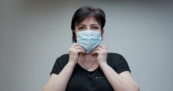 Senior Woman Takes on Medical Mask