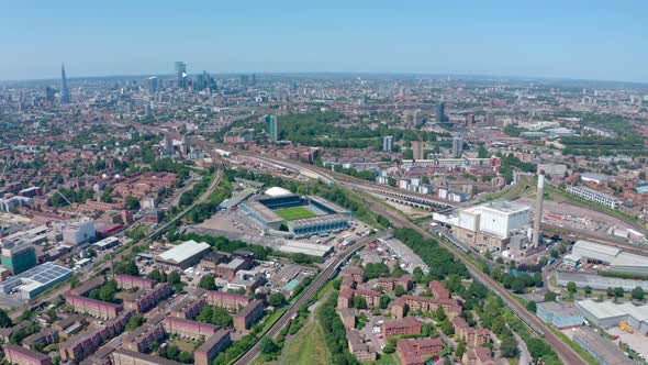 Dolly forward drone shot over Bermondsy millwall stadium London skyline