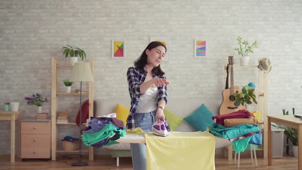 Cheerful Young Woman in Plaid Shirt Ironed Linen Iron at Home